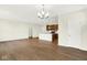 Bright living room featuring hardwood floors, modern chandelier, and an open view to the kitchen at 19725 Highclere Lane, Sheridan, IN 46069