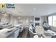 Open-concept living room and kitchen area with granite countertops, stainless steel appliances, and a cozy fireplace at 19725 Highclere Lane, Sheridan, IN 46069