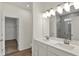 Bright bathroom featuring double sinks, wood-look floors, and a walk-in shower at 19762 Highclere Lane, Sheridan, IN 46069