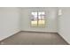 This bedroom features neutral carpet, white walls, and a large window at 19762 Highclere Lane, Sheridan, IN 46069