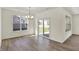 Bright dining room with hardwood floors, large windows, and sliding doors leading to the patio at 19762 Highclere Lane, Sheridan, IN 46069