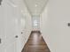 Clean, bright hallway with hardwood flooring leading to a front door with glass window at 19762 Highclere Lane, Sheridan, IN 46069