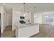 Modern kitchen with stainless steel appliances, white cabinets, and a spacious island at 19762 Highclere Lane, Sheridan, IN 46069
