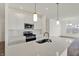 Modern kitchen featuring stainless steel appliances, white cabinets and a large central island at 19762 Highclere Lane, Sheridan, IN 46069