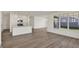 Bright living room with a view of the modern kitchen featuring stainless steel appliances and white cabinets at 19762 Highclere Lane, Sheridan, IN 46069