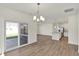 Bright and airy open-concept living space with wood floors and sliding door to the outdoor patio at 19762 Highclere Lane, Sheridan, IN 46069