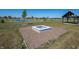Community fire pit is surrounded by ample green space, with a pond, fountain and gazebo visible in the background at 2039 Quail West Dr, Danville, IN 46122