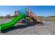 A vibrant green, blue and orange playground, part of community amenities, set against a backdrop of a pond at 2039 Quail West Dr, Danville, IN 46122