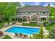 Aerial view of private backyard oasis with pool, sun loungers, and outdoor living spaces at 2055 Mulsanne Dr, Zionsville, IN 46077