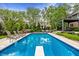 Backyard view of a pool, diving board, green space, and outdoor dining area under pergola at 2055 Mulsanne Dr, Zionsville, IN 46077