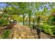 Landscaped backyard with stone patio, pergola, outdoor dining and beautiful pool area at 2055 Mulsanne Dr, Zionsville, IN 46077