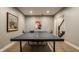 Basement game room area with ping pong table and decorative artwork at 2055 Mulsanne Dr, Zionsville, IN 46077