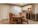 Cozy dining area features wooden table and chairs, wet bar, cabinets, and wine cooler at 2055 Mulsanne Dr, Zionsville, IN 46077