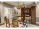 Stylish dining room featuring a glass-top table, modern lighting, and a unique hutch at 2055 Mulsanne Dr, Zionsville, IN 46077