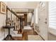 Elegant foyer featuring hardwood floors, a staircase with a black railing, and ample natural light at 2055 Mulsanne Dr, Zionsville, IN 46077