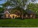 Charming brick home with a well-manicured lawn and mature tree, creating a picturesque curb appeal at 2055 Mulsanne Dr, Zionsville, IN 46077