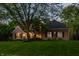 Beautiful brick home with manicured lawn and mature trees, featuring a welcoming front entrance at 2055 Mulsanne Dr, Zionsville, IN 46077