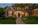 Charming brick home exterior with lush landscaping, a stone walkway and elegant front door at 2055 Mulsanne Dr, Zionsville, IN 46077