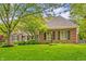 Charming brick home with a lush front yard and mature trees at 2055 Mulsanne Dr, Zionsville, IN 46077