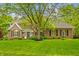 Attractive brick home with well-maintained lawn, mature trees, and black shutters at 2055 Mulsanne Dr, Zionsville, IN 46077