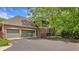 Spacious three car garage alongside lush landscaping and a basketball hoop at 2055 Mulsanne Dr, Zionsville, IN 46077