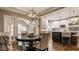 Bright kitchen and breakfast nook features wood floors, pendant lights, and stainless steel appliances at 2055 Mulsanne Dr, Zionsville, IN 46077