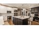 Modern kitchen features stainless appliances, a large island with seating, and sleek cabinetry at 2055 Mulsanne Dr, Zionsville, IN 46077
