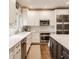 Bright kitchen features white cabinetry, stainless appliances, and quartz countertops at 2055 Mulsanne Dr, Zionsville, IN 46077