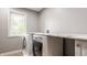 Well-lit laundry room featuring modern washer and dryer with marble countertop at 2055 Mulsanne Dr, Zionsville, IN 46077