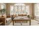 Sunroom with large windows, comfortable seating, and tranquil garden views at 2055 Mulsanne Dr, Zionsville, IN 46077