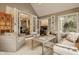 Sunroom features comfortable seating, neutral tones, and multiple french door access to the main house at 2055 Mulsanne Dr, Zionsville, IN 46077