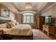 Bright main bedroom features a large window, tray ceiling, and hardwood floors at 2055 Mulsanne Dr, Zionsville, IN 46077