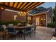Cozy outdoor dining area under a pergola with stylish chairs and a backyard view at 2055 Mulsanne Dr, Zionsville, IN 46077