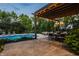 Outdoor patio area with a chandelier, a dining table, lounge chairs and a view of the pool at 2055 Mulsanne Dr, Zionsville, IN 46077