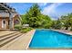 Backyard view of a rectangular pool, patio, and outdoor stairs leading to pergola at 2055 Mulsanne Dr, Zionsville, IN 46077