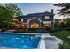 A large backyard swimming pool with diving board and a view of the home at 2055 Mulsanne Dr, Zionsville, IN 46077