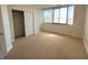 Bedroom featuring wall-to-wall carpet, window, and closet at 225 N New Jersey St # 46, Indianapolis, IN 46204