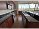 Modern kitchen with stainless steel appliances, dark countertops, wood cabinets and hardwood floors at 225 N New Jersey St # 46, Indianapolis, IN 46204