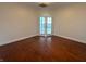 Spacious living room with hardwood floors and bright double doors to the outside at 225 N New Jersey St # 46, Indianapolis, IN 46204