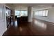 Open-concept living area with hardwood floors connecting a modern kitchen with city views at 225 N New Jersey St # 46, Indianapolis, IN 46204