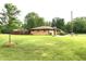Ranch home with spacious backyard lawn and mature trees at 2315 Redfern Dr, Indianapolis, IN 46227