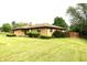 Brick ranch style home with a spacious backyard lawn at 2315 Redfern Dr, Indianapolis, IN 46227