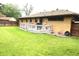 Large backyard featuring a well-maintained lawn and a wooden deck at 2315 Redfern Dr, Indianapolis, IN 46227