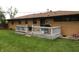 Backyard featuring a well-maintained lawn, a wooden deck and a brick house at 2315 Redfern Dr, Indianapolis, IN 46227