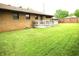 Lush backyard view showcasing the green lawn, wooden deck and a glimpse of the home's exterior at 2315 Redfern Dr, Indianapolis, IN 46227