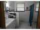 Bathroom with white tile, marble floors and shower with curtain at 2315 Redfern Dr, Indianapolis, IN 46227