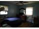 Cozy bedroom featuring a ceiling fan, dresser, and natural light from the windows at 2315 Redfern Dr, Indianapolis, IN 46227