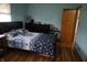 Well-lit bedroom with a large bed, dark wood furniture and floral decorations at 2315 Redfern Dr, Indianapolis, IN 46227