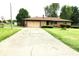 Charming home featuring a driveway, an attached garage, and an expansive front lawn at 2315 Redfern Dr, Indianapolis, IN 46227