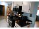 Efficient kitchen with black appliances, white cabinets, and ample counter space at 2315 Redfern Dr, Indianapolis, IN 46227